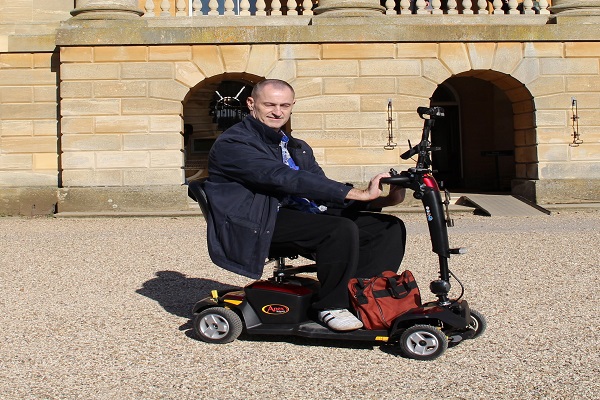 Andy Wright traveling on mobility scooter